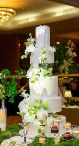 tall wedding cake with dessert table